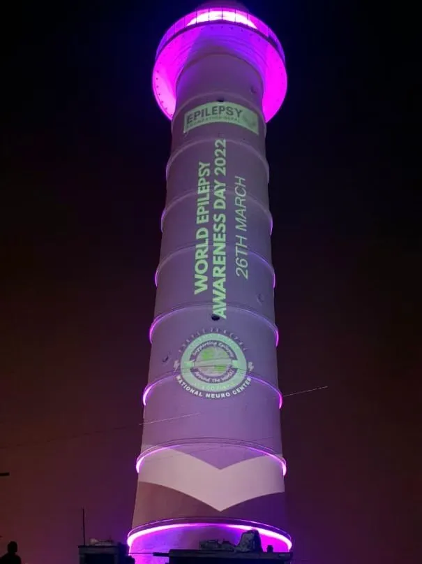 The tower lit purple with the title World Epilepsy Awareness Day 2022, 26th March, the Epilepsy Foundation Nepal logo and the National Neuro Center emblem.