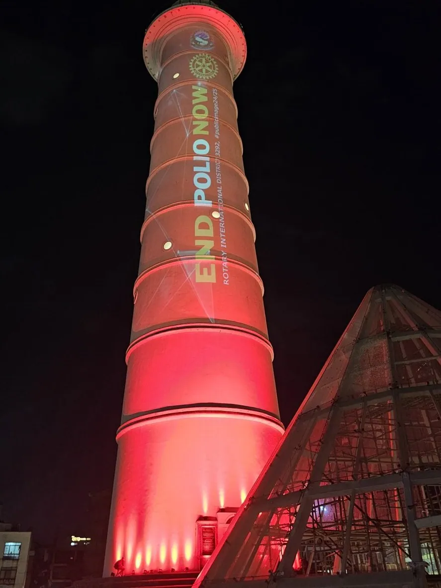Low view of the red tower with the Rotary logo, the End Polio Now title and the hashtag publicimage24/25 on the shaft.