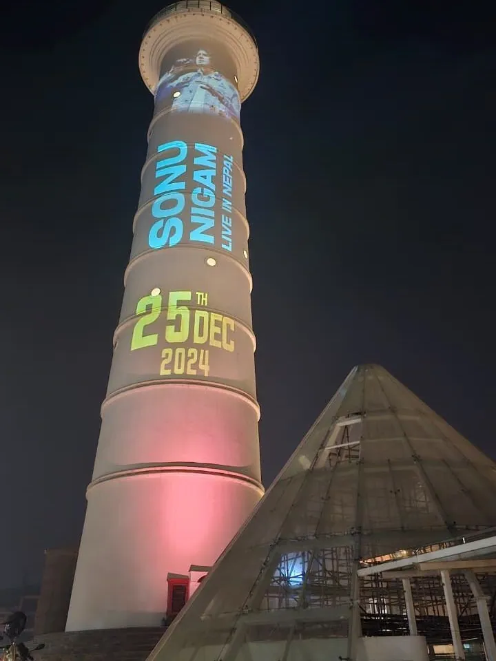 The tower at night with Sonu Nigam in vertical blue lettering and the date 25 December 2024.