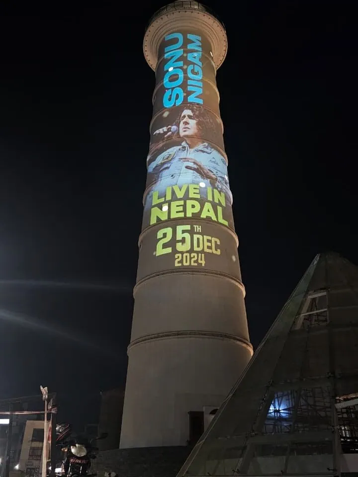 The tower at night with a photograph of the singer and the words Sonu Nigam Live in Nepal, 25th December 2024.