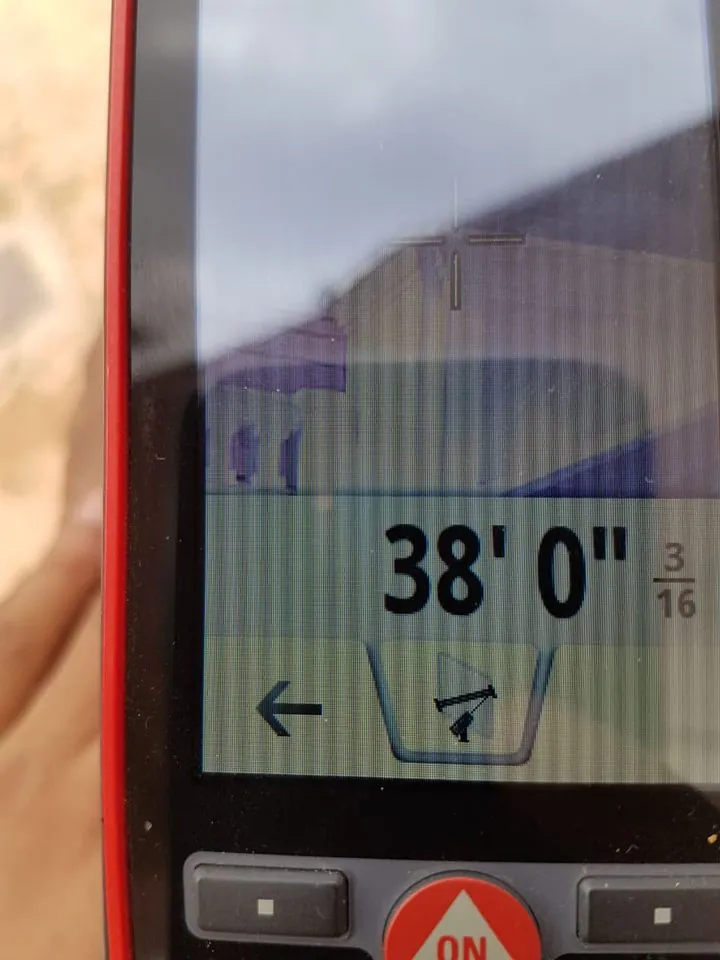 Leica DISTO S910 display reading 38 feet 0 3/16 inches.