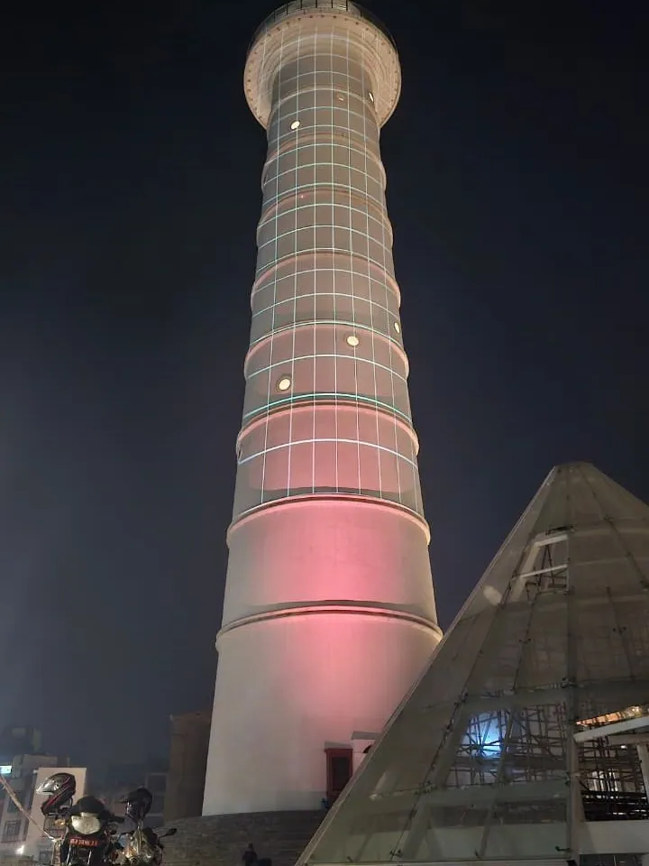 The bare tower with a fine grid of cyan lines projected over its shaft.